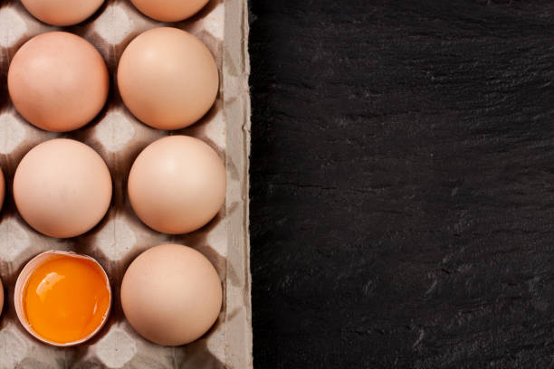 istock eggs in a tray on a dark background with copy space for your text. Top view 656971848