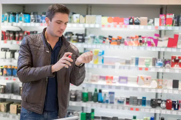 Man trying on perfume