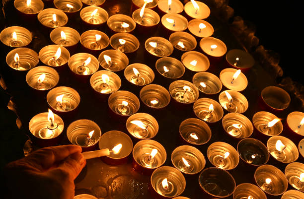 istock person lights a candle during the religious ceremony 656977388