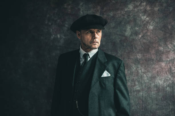 istock Retro 1920s english gangster wearing flat cap and suit. 656983078