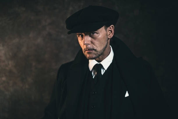 Retro 1920s english gangster. Peaky blinders style. Retro 1920s english gangster. Peaky blinders style. flat cap stock pictures, royalty-free photos & images