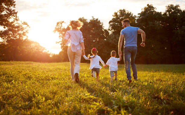 istock Family running with children in nature, back view 656986568