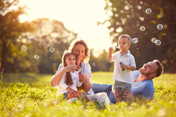 istock Family with children blow soap bubbles 656986616