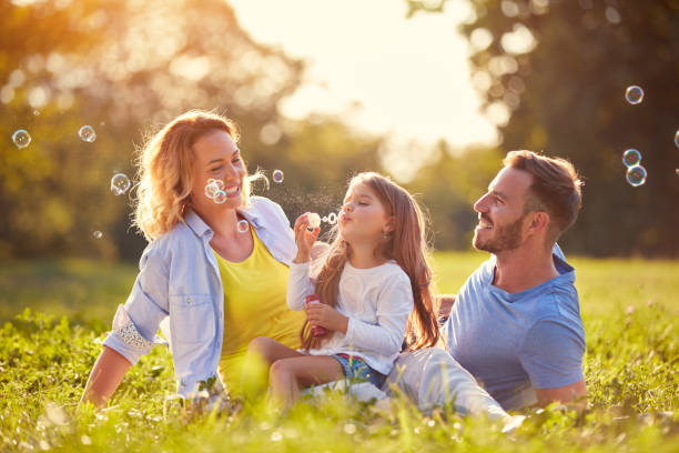 istock Family with children blow soap bubbles 656986674