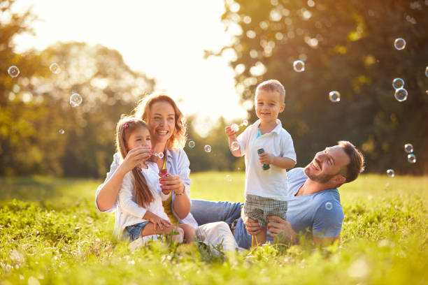 istock Family with children blow soap bubbles 656986768
