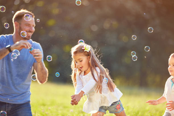 istock Girl catch soap bubbles outside 656987576