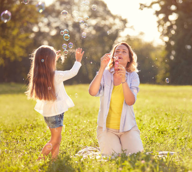 istock Girl chase soap bubbles in park 656987666
