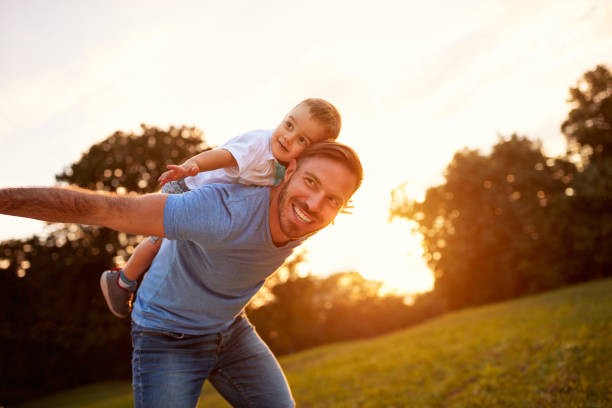 istock Happy young father with son in park 656990676