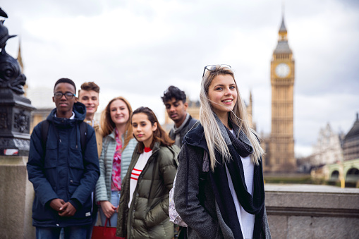 Group of young teenagers enjoying a school trip in London, they're visiting Westminster areas.