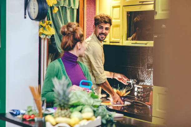 istock Smiling couple cooking together 657006340