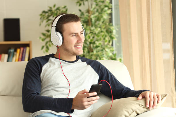 istock Guy listening music relaxing at home 657006916