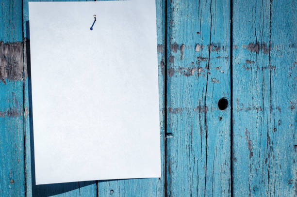 istock blank white piece of paper hanging on a nail 657010258