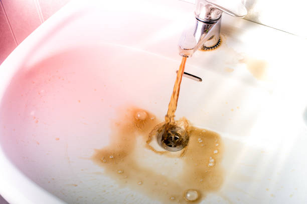 istock Dirty brown water running into a sink 657017284