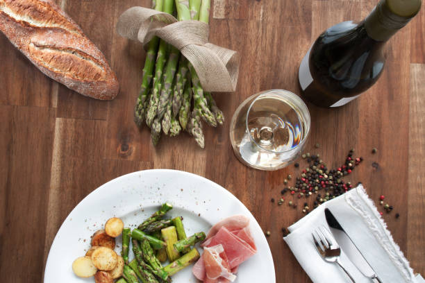 Still life with asparagus and wine on a rustic wooden table for a healthy meal
