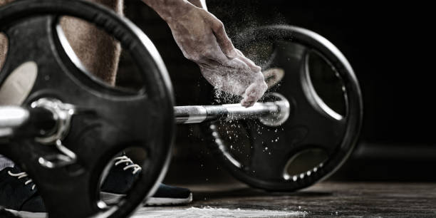 Sports background. Young athlete getting ready for weight lifting training. Powerlifter hand in talc preparing to bench press Sport and fitness sports chalk stock pictures, royalty-free photos & images