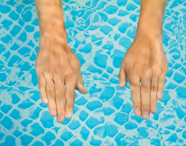istock Young sweet woman's hand in a swimming pool 657020928