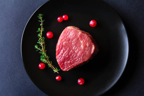istock Raw meat on black plate and dark background 657021100