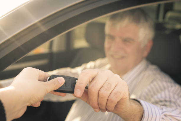 istock Senior man holding a car key. 657024566