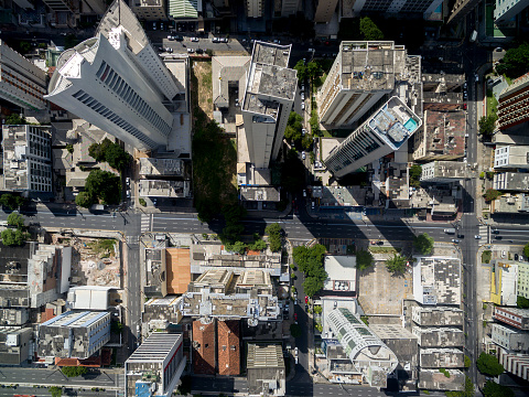 Overhead top down birds eye aerial view of patterns of red rooftops of traditional houses with narrow streets in Lisbon city center