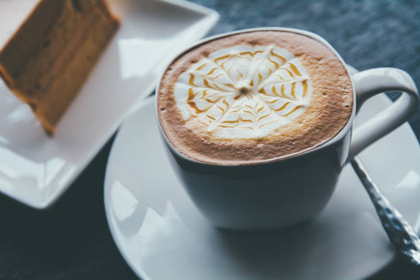 istock Coffee cup and saucer on a wooden table, shallow DOF 657027542