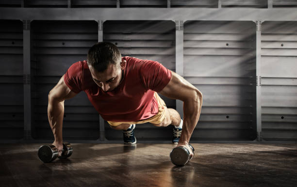 Sport. Handsome man doing push ups exercise with one hand in fitness gym Sport and Fitness dumbbell photos stock pictures, royalty-free photos & images