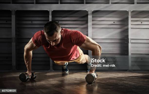 Sport Handsome Man Doing Push Ups Exercise With One Hand In Fitness Gym Stock Photo - Download Image Now