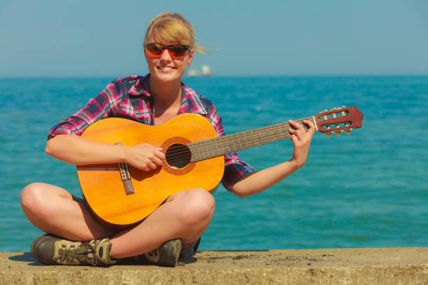 istock Young woman with guitar outdoor 657028122