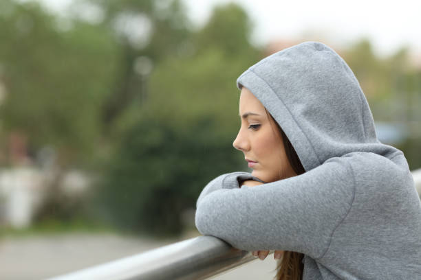 istock Sad teenager looking down in a balcony 657028602