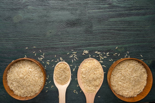 istock Wooden spoons and bowls with rice 657031162