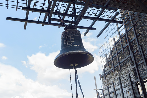 Kiev, Ukraine - May 05, 2016: Bell on a background of a metal cage. The memorial complex to the victims of Holodomor in Ukraine in 1932-1933