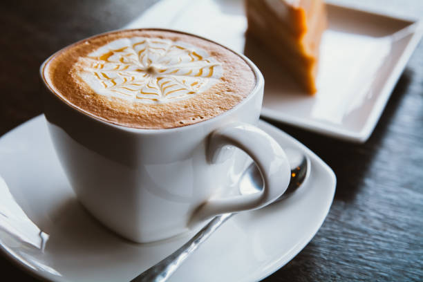 istock Coffee cup and saucer on a wooden table, shallow DOF 657042880