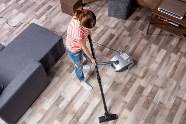 istock Woman with vacuum cleaner 657048910