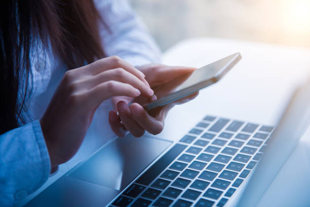 istock Businesswomen holding mobile phone in office 657049522