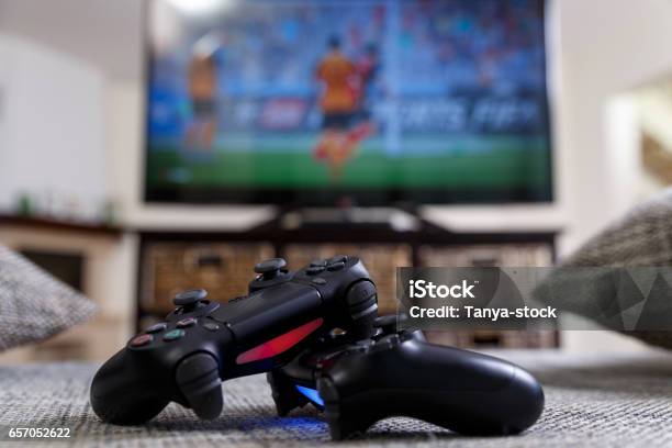 Playing Video Game Console Controllers Stock Photo - Download Image Now - Video Game, Television Set, Soccer