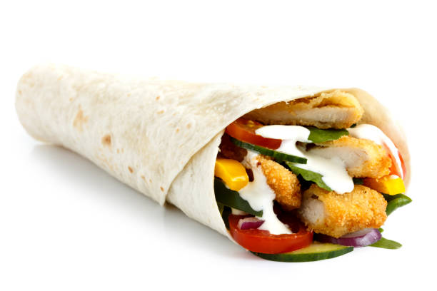 istock Crumbed fried chicken and salad tortilla wrap with white sauce isolated on white. 657056932