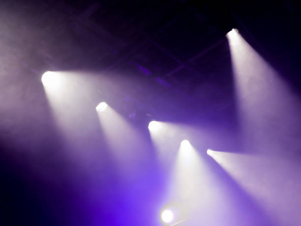 istock The light rays from the spotlight through the smoke. Lighting equipment on the ceiling. The stage of a theatre or night club. Show or performance. 657066190