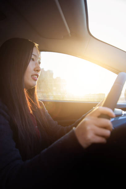 istock Young woman driving car 657066270