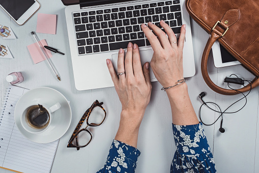 Overhead Business Angles woman at office desk with supply