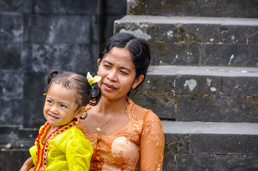 Mother and daughter in Pura Besakih Temple in Bali Island, Indonesia