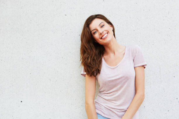 istock attractive young lady smiling against white background 657079870