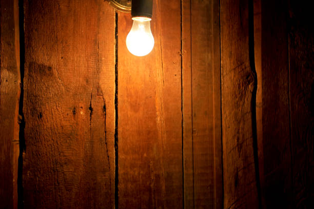 istock Electric light bulb on wooden background 657080078