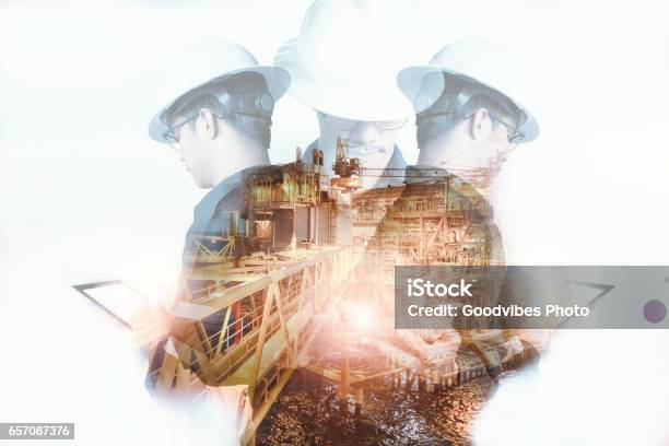 Double Exposure Of Engineer Or Technician Man With Safety Helmet Operated Platform Or Plant By Using Tablet With Offshore Oil And Gas Platform Background For Oil And Gas Business Concept Stock Photo - Download Image Now