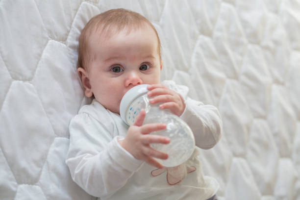 istock Baby is drinking milk out of a bottle 657090750
