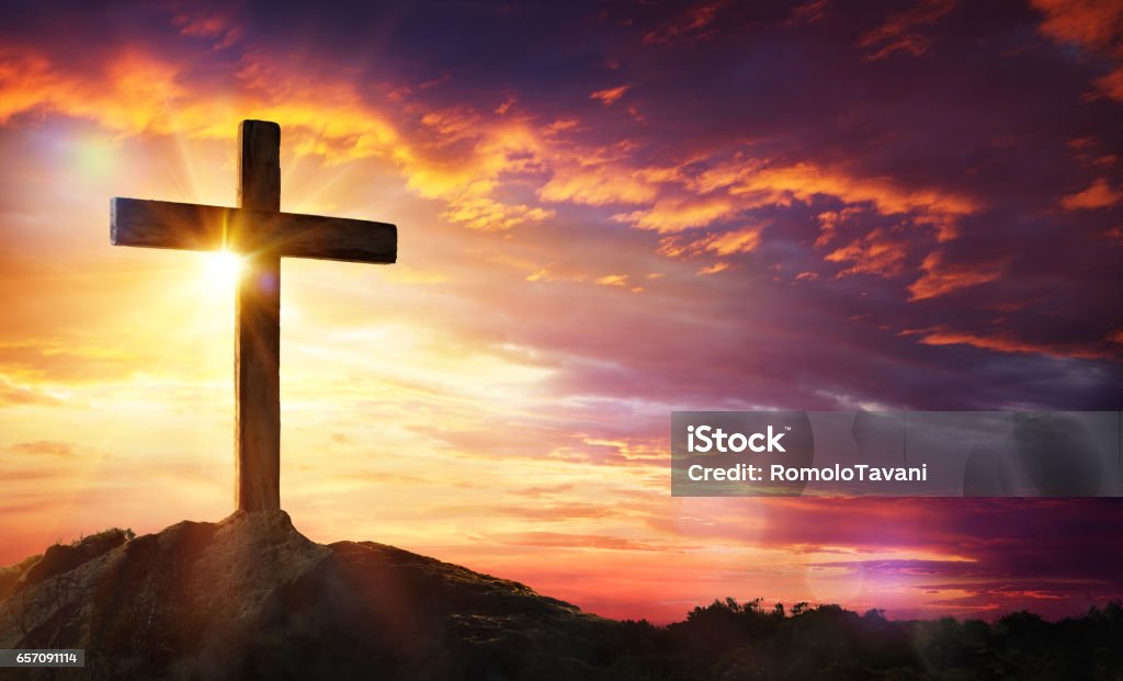 Crucifixion Of Jesus Christ Cross At Sunset With Sunlight And Orange Clouds Religious Cross Stock Photo