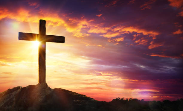 Crucifixion Of Jesus Christ Cross At Sunset With Sunlight And Orange Clouds religious cross stock pictures, royalty-free photos & images