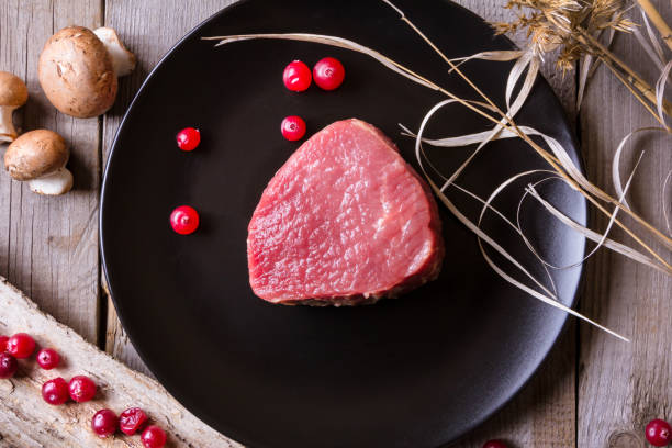istock Fresh game meat on black plate and wooden table 657106290