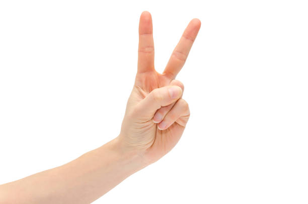 istock hand of young girl shows Victory 657107964