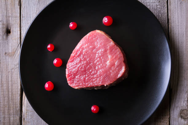istock Fresh game meat on black plate and wooden table 657111284