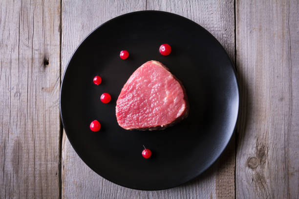 istock Fresh game meat on black plate and wooden table 657116584