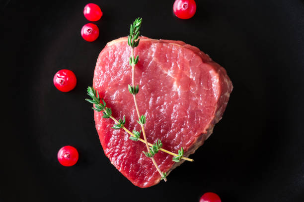 istock Raw meat on black plate and dark background 657118822